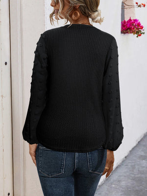 Black waffle knit blouse with Swiss dot sleeves and tie front detail