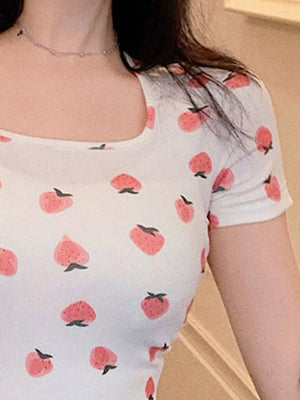 White square neck t-shirt with a pink peach print and short sleeves.