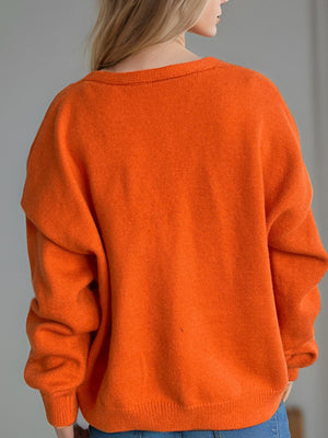 Orange acrylic oversized knit cardigan with crew neck and long sleeves
