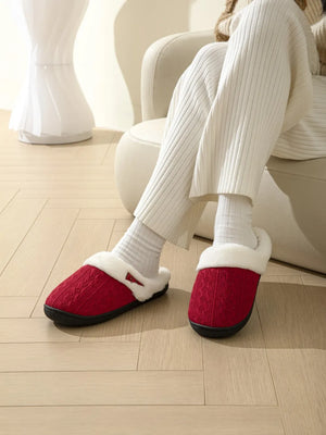 Deep Red cable knit shearling house slippers with white trim.