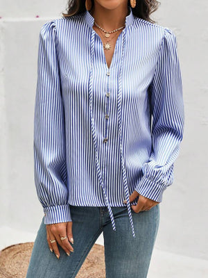 Light blue striped blouse with puffed sleeves, keyhole neckline, and tie detail.
