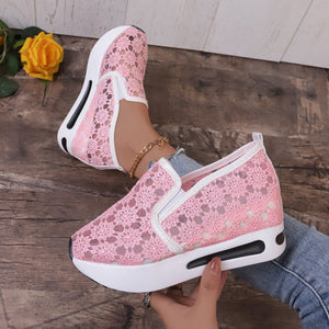 Pink floral lace slip-on sneakers with a chunky white sole and breathable mesh detail.