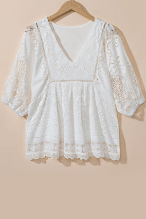 White lace peplum blouse with V-neck, 3/4 sleeves, and scalloped hem detail.