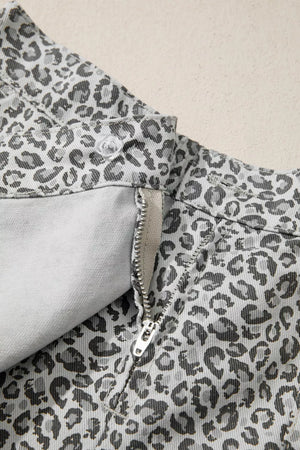 Denim shorts with leopard print, zipper fly, and button closure.