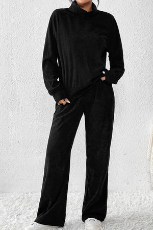 Black corduroy turtleneck loungewear set with long sleeves and wide-leg pants.