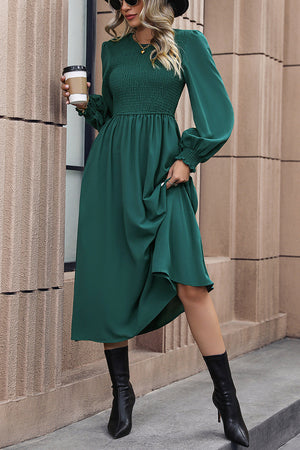 Gathered bodice midi dress in dark green polyester with long sleeves and smocked torso.