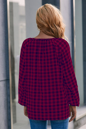 Burgundy plaid blouse with gathered neckline and balloon sleeves.