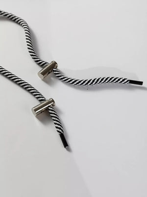 Drawstring waist tunic sweatshirt detail with black and white striped cord and silver hardware.