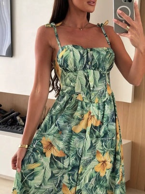 Floral tie-strap midi dress in Matcha Green with a tropical leaf and flower print.