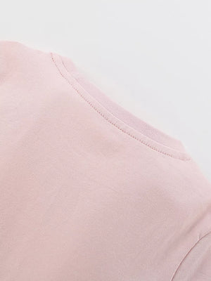 Blush pink cotton blend toddler dress detail showing neckline and stitching.