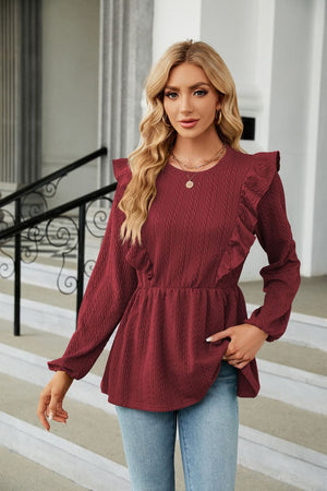 Textured ruffle peplum blouse in wine with long sleeves and crew neck.