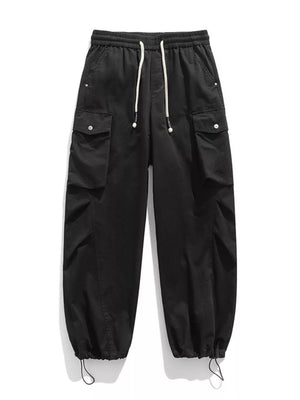 Black cargo pants with drawstring waist and hem, featuring button-flap pockets.
