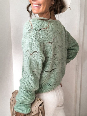 Light green scalloped knit cardigan with openwork pattern and balloon sleeves.