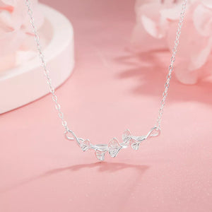 Silver necklace with delicate ginkgo leaf design and fine chain.