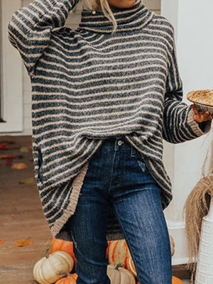 Oversized striped turtleneck sweater with slouch pockets in black and tan, styled with jeans.