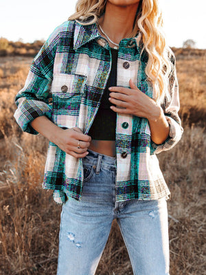 Plaid pocket long sleeve shirt jacket in dark green and black with button details.