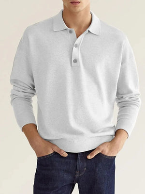 Relaxed gray knit polo shirt with button placket and long sleeves.