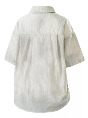 Relaxed fit camp collar men's shirt in off-white with short sleeves and a buttoned front.