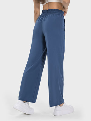 Relaxed drape drawstring palazzo pants in Dusty Blue with wide legs and pockets.