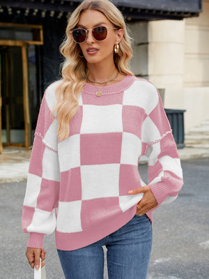 Checkerboard knit sweater in blush pink and white with balloon sleeves and crew neck.