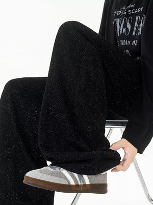 Black textured knit sweatpants with a subtle sparkle detail, shown on a model.