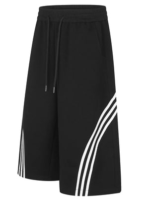 Black cropped wide-leg sweatpants with white stripe detail and drawstring waist.