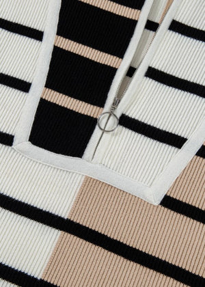 Colorblock ribbed zip polo with black, white, and tan stripes.