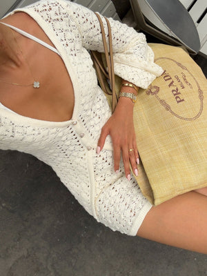 Cream crochet knit button-down sweater dress with open knit detail and shell buttons.