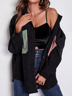 Black corduroy overshirt with contrast patch pockets and button cuffs.