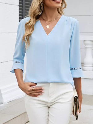 Sky blue V-neck blouse with 3/4 sleeves and lace trim detail.