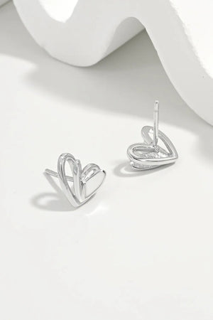 Open heart silhouette stud earrings in silver with a delicate, modern design.