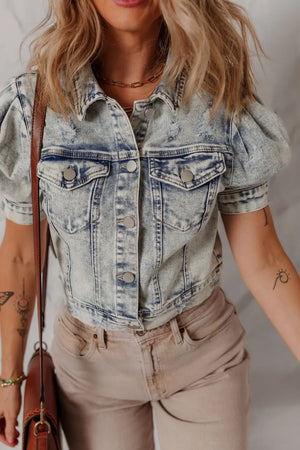 Cropped denim bolero jacket in medium wash with puff sleeves and distressed details.