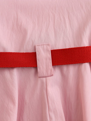 Pink cotton blend baseball dress for kids with red adjustable belt detail.