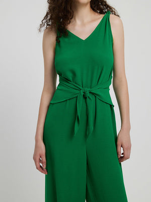 Emerald tie-waist wide leg jumpsuit with V-neck and tie shoulder straps.