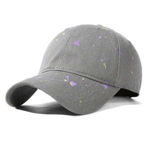 Gray cotton baseball cap with purple and yellow splatter paint detail.