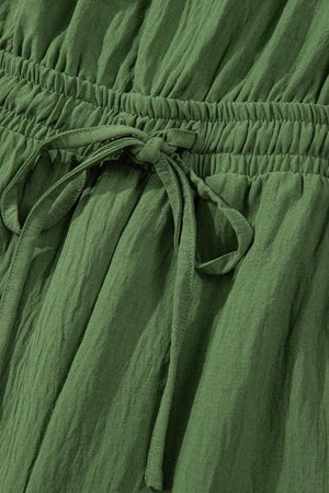 Textured drawstring palazzo jumpsuit in Matcha Green with crinkled fabric detail.