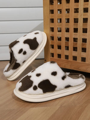 Cow print faux fur house slides in white and brown with a thick sole.