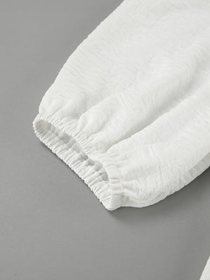 White textured midi dress with elasticated cuffs and sleeves.