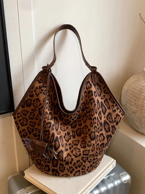 Brown leopard print tote bag with brown trim and shoulder strap, sunglasses attached.