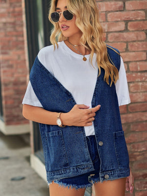 Oversized denim vest in medium blue with patch pockets and button front.