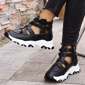 Black chunky cutout platform sneakers with ankle straps and white soles.