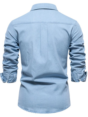 Light blue faded denim utility shirt with button cuffs and a classic collar.