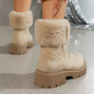 Creamy-white suede ankle boots with faux fur trim and chunky sole.