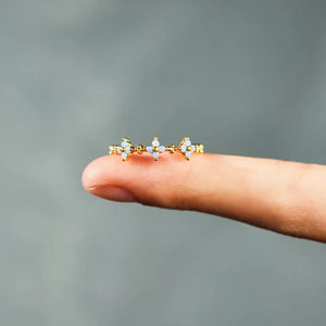 Gold band ring with celestial blossom details and small white stones