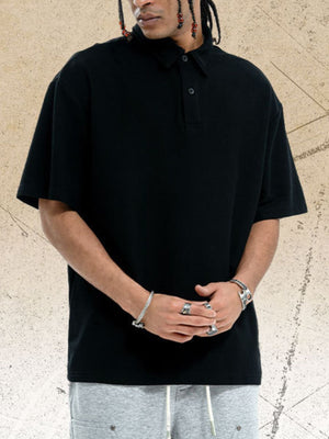 Black cotton polo shirt with buttoned collar and short sleeves