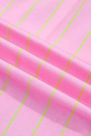 Pink polo shirt with neon green vertical stripes, fabric detail