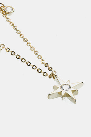 Gold celestial compass pendant necklace with moissanite detail on a delicate chain.