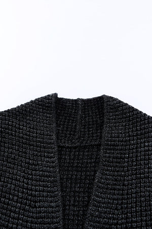 Textured acrylic open cardigan in black with a waffle knit pattern.