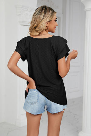 Black eyelet knit blouse with flutter sleeves and v-neck, styled with denim shorts.
