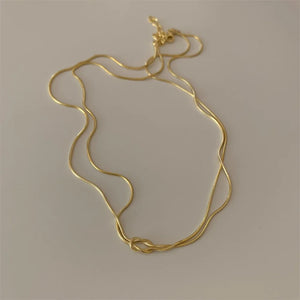 Gold snake chain necklace with a knot detail